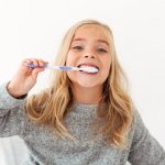 Child brushing teeth